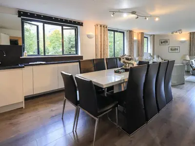 a dining room and kitchen with a table and chairs at Le Chalet in Elterwater