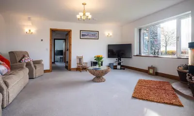 a living room with a couch and a tv at Sherriff in Penrith