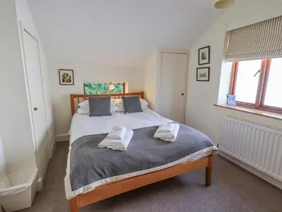 a bedroom with a bed with two towels on it at Croft in Grasmere