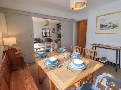 a dining room with a wooden table and chairs at Croft in Grasmere