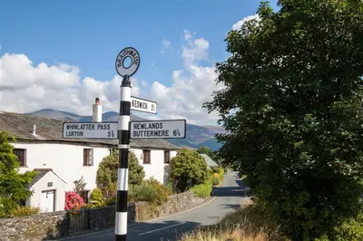 a street sign on a pole with street signs at Gable End in Keswick