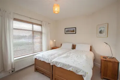 a bedroom with a large bed and a window at The Haven in Keswick