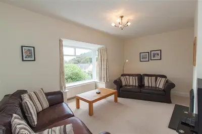 a living room with two leather couches and a table at The Haven in Keswick