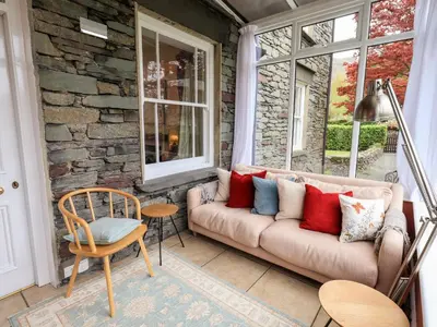 a living room with a couch and a window at Holmdale in Ambleside