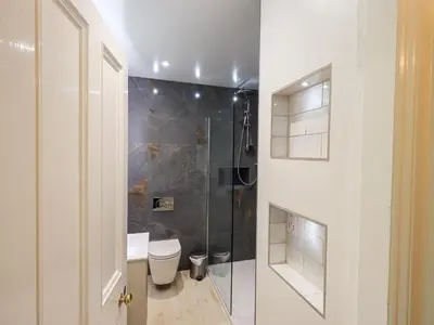 a bathroom with a toilet and a glass shower at Holmdale in Ambleside