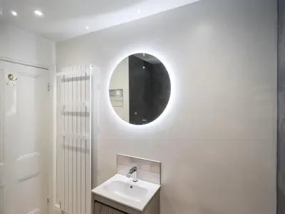 a bathroom with a sink and a mirror on the wall at Holmdale in Ambleside