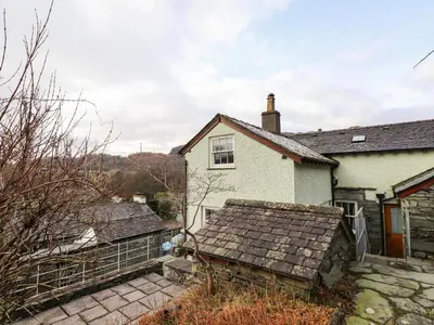 a white house with a fence in front of it at Underfell in Ambleside