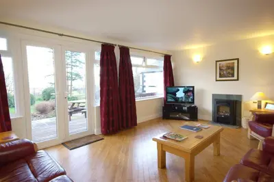 a living room with a couch and a table at Pen Cottage in Keswick