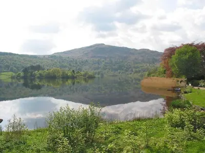 a view of a lake with a mountain in the background at Dove Holme Cottage in Grasmere