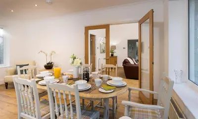 a dining room with a table and chairs at Lanterns At Grasmere in Grasmere