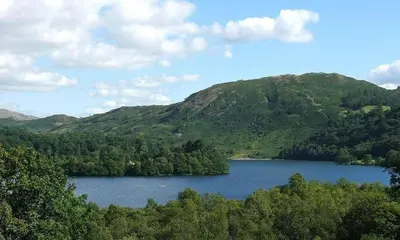 a view of a lake in front of a mountain at Lanterns At Grasmere in Grasmere