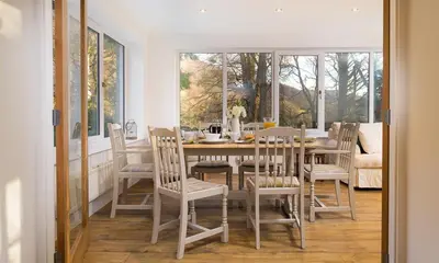 a dining room with a table and chairs at Lanterns At Grasmere in Grasmere