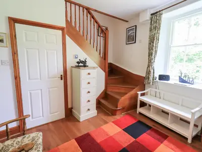 a room with a staircase and a white door at Drystones in Grasmere