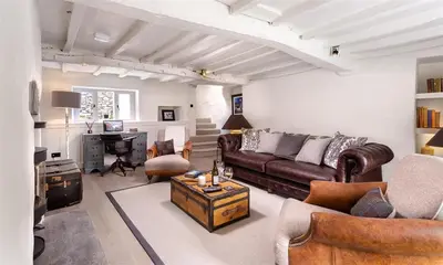 a living room with a couch and a desk at Underhowe in Grasmere