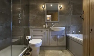 a bathroom with a toilet and a sink and a shower at Cedar Nook in Loweswater