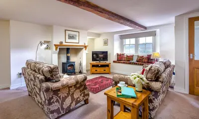 a living room with two couches and a tv at Low Longthwaite Farm in Watermillock