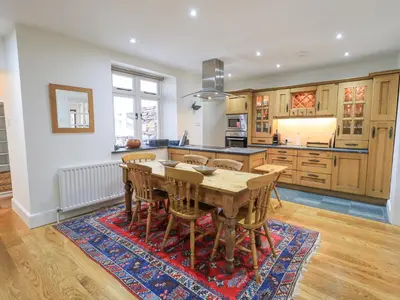 a large kitchen with a wooden table and chairs at Rowan Cottage in Grasmere