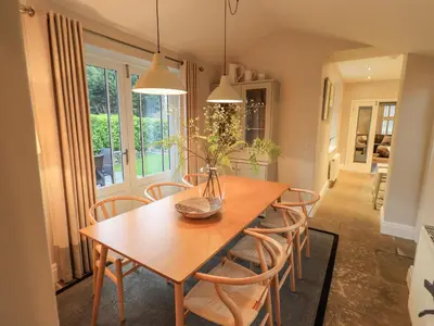 a dining room with a wooden table and chairs at Honeywood House in Grasmere