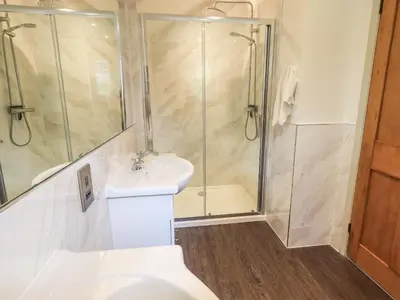 a bathroom with a shower and a toilet and a sink at Rawfell in Ambleside
