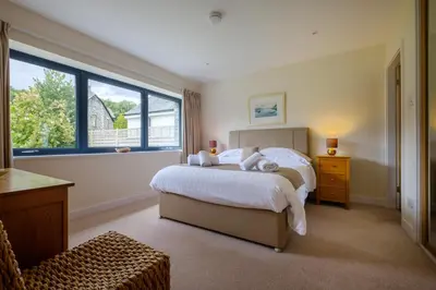 a bedroom with a large bed and a window at The Old Police House in Grasmere