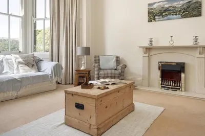 a living room with a couch and a fireplace at Wetherlam in Ambleside