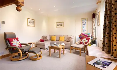 a living room with a couch and chairs at Lingmoor View in Ambleside