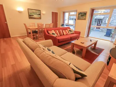 a living room with a couch and a table at Molly's Cottage in Grasmere