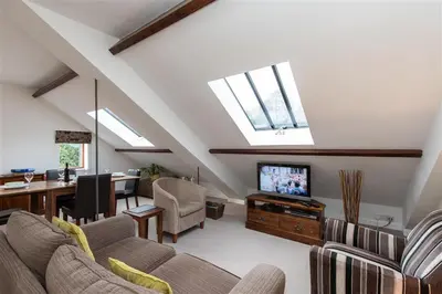 a living room with a couch and a tv at The Gallery in Grasmere