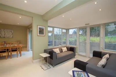 a living room with a couch and a dining room at Riggside in Keswick