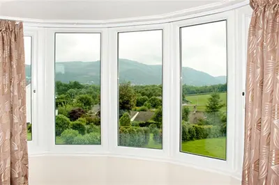 a room with three windows with a view at Riggside in Keswick