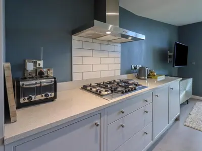 a kitchen with a stove and a counter top at Gillside in Keswick