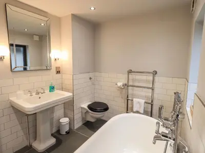 a bathroom with a sink and a toilet and a tub at Gillside in Keswick