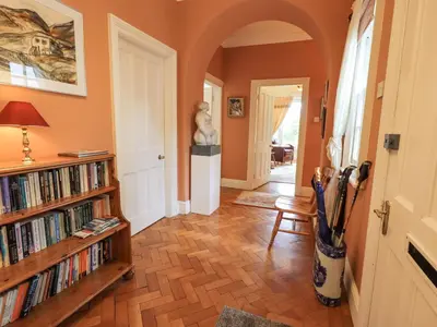 a hallway with a book shelf filled with books at Grisedale View in Keswick