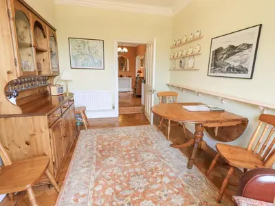 a living room with a wooden table and chairs at Grisedale View in Keswick
