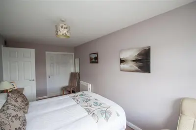 a bedroom with a bed and a picture on the wall at Mellbreak in Chapel Stile