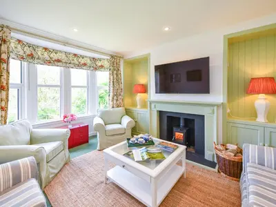 a living room with a couch and a fireplace at Pinclanty Cottage in Pinmore