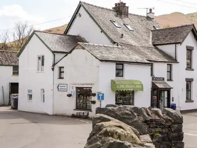 an old white building on the side of a street at Holme Rigg in Keswick