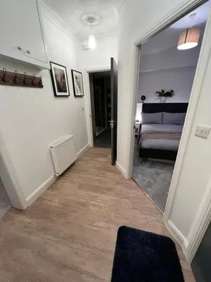 a hallway with a door leading to a bedroom at Modern Town-Centre Apartment in Dumfries