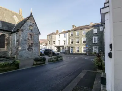 an empty street in a small town with buildings at Carlton House Apartment 1 in Keswick
