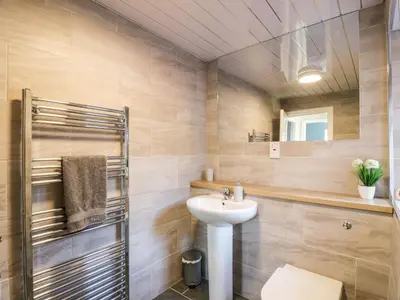 a bathroom with a sink and a toilet and a mirror at Rothiemay in Girvan