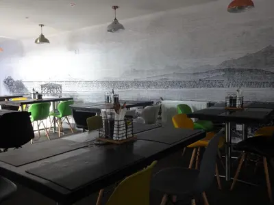 a restaurant with tables and chairs and a mural on the wall at Bowness Bed & Breakfast Double Room, Bowness-on-Solway in Bowness-on-Solway