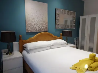 a bedroom with a bed with a teddy bear on it at John Collingwood, Bowness-on-Solway ideal for starting of finishing a walk along Hadrians Wall in Bowness-on-Solway