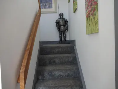 a stairway with a statue sitting on top of it at John Collingwood, Bowness-on-Solway ideal for starting of finishing a walk along Hadrians Wall in Bowness-on-Solway