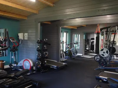 a gym with several treadmills and bikes in it at John Collingwood, Bowness-on-Solway ideal for starting of finishing a walk along Hadrians Wall in Bowness-on-Solway
