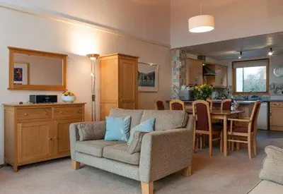 a living room with a couch and a dining room at Keswick Bridge 22, within walking distance of Keswick town centre, strictly no pets in Keswick