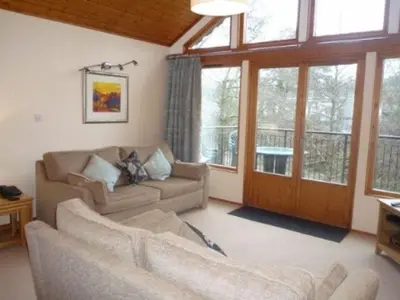 a living room with two couches and a large window at Keswick Bridge 22, within walking distance of Keswick town centre, strictly no pets in Keswick