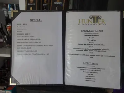 a menu for a restaurant with two white signs at Ryans Retreat, Bowness on Solway perfect for a break when walking Hadrians Wall with a hot tub in Bowness-on-Solway
