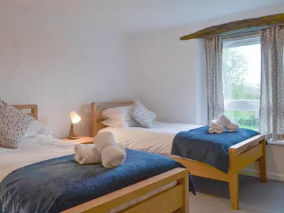 a bedroom with two beds and a window at The Retreat in Sunderland