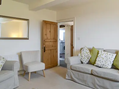 a living room with two couches and a mirror at The Retreat in Sunderland