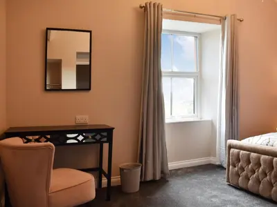 a bedroom with a mirror and a desk and a window at Ivy House in Dockray